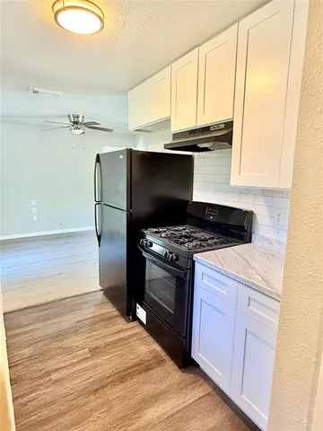 a kitchen with a stove and a microwave
