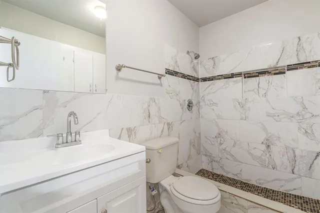 a bathroom with a sink toilet and shower