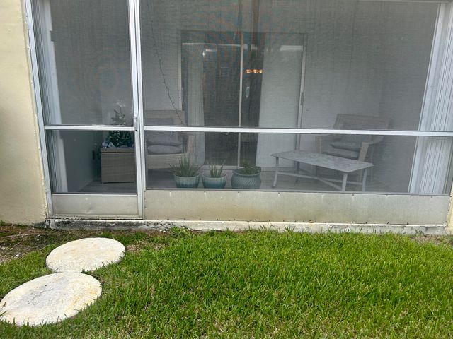 a view of a patio with a table and chairs