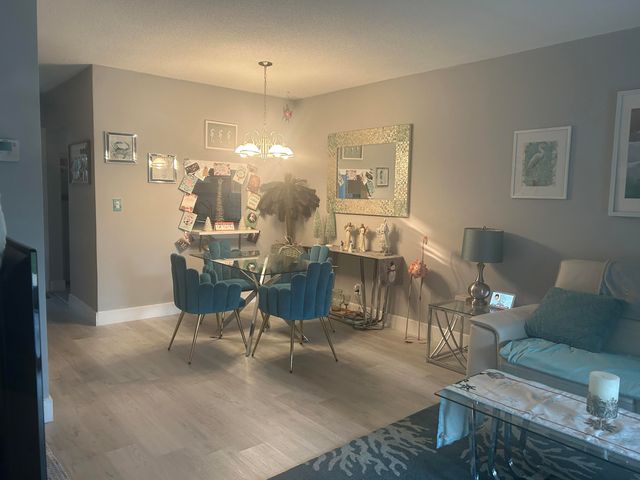 a living room with furniture a flat screen tv and a large window