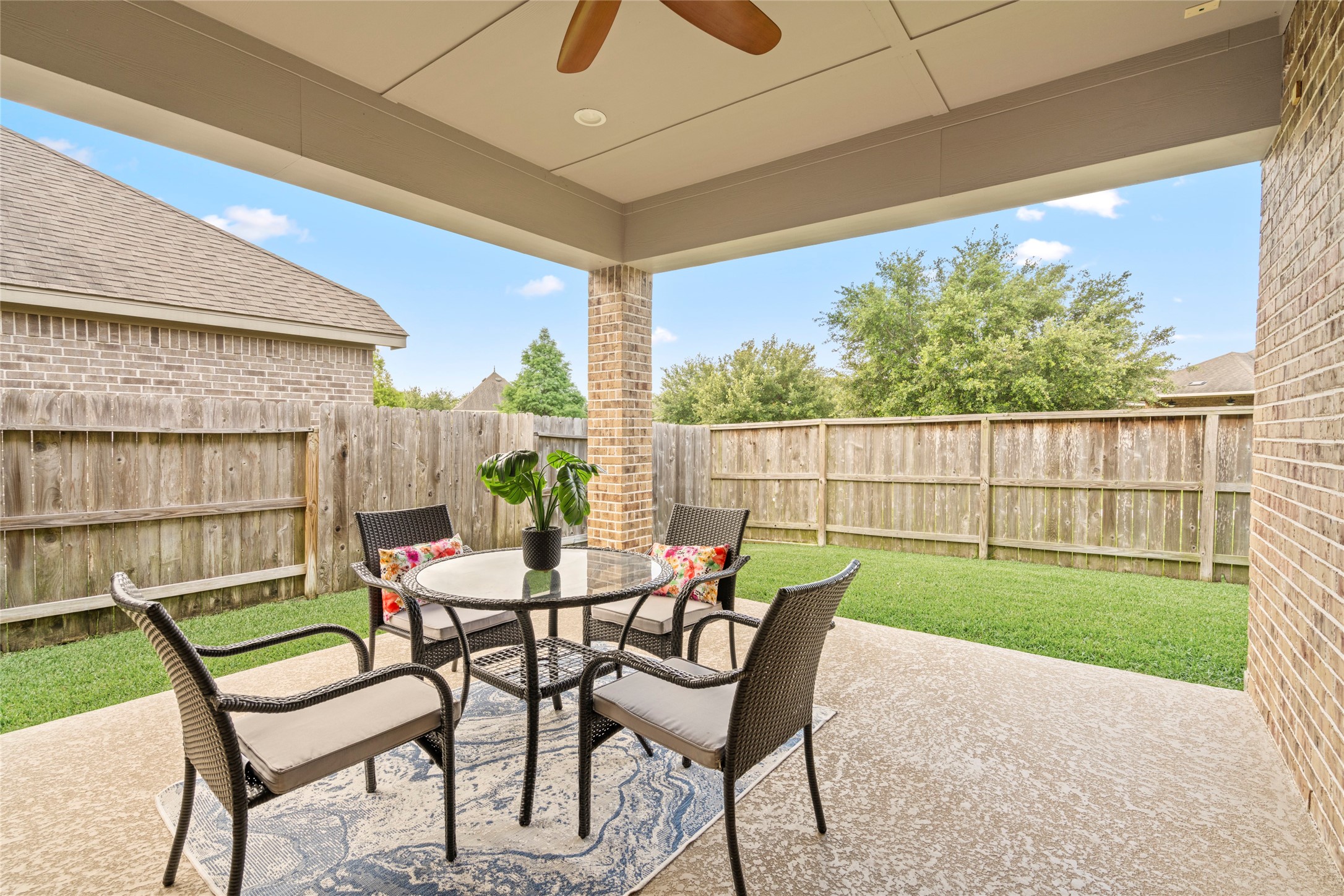 143 Castlegate Lane Houston, TX 77065 - Photo 26 of 33 Inviting covered patio with ceiling fan for outdoor enjoyment. Seller added power for future lighting, ethernet for wifi & camera, & coax for potential outdoor TV.