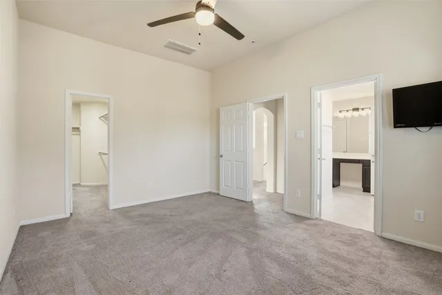 an empty room with windows and fireplace