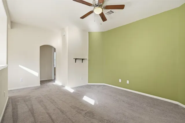 a view of a room with a ceiling fan