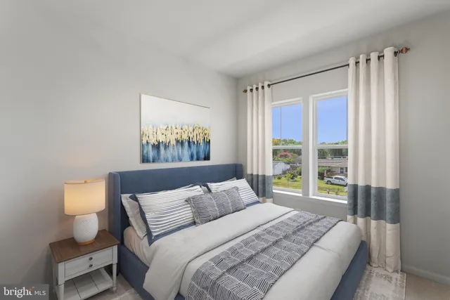 a bedroom with a bed and a lamp next to a window