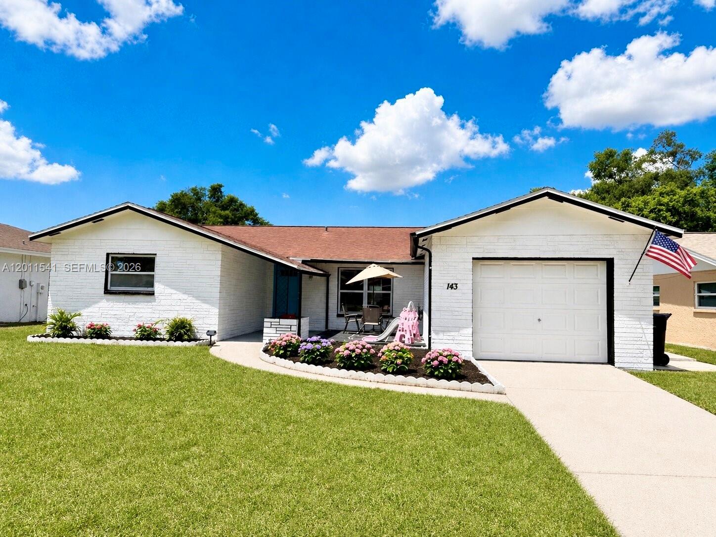 143 Valley Circle Brandon, FL 33510 - Photo 1 of 21 a front view of house with yard and outdoor seating