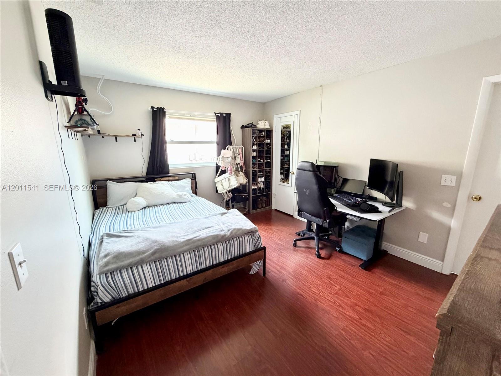 143 Valley Circle Brandon, FL 33510 - Photo 11 of 21 a bedroom with a bed a desk and chair