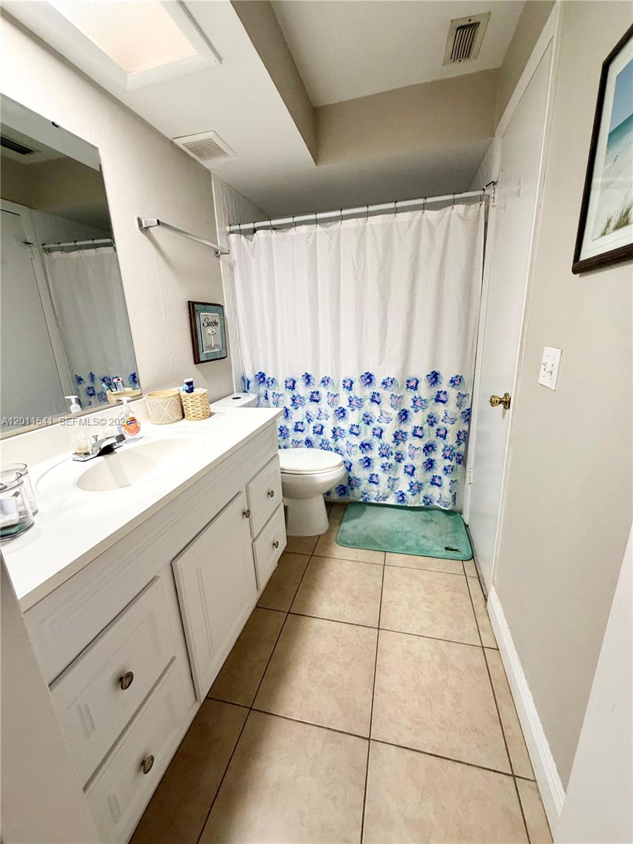 143 Valley Circle Brandon, FL 33510 - Photo 14 of 21 a bathroom with a sink a toilet and shower