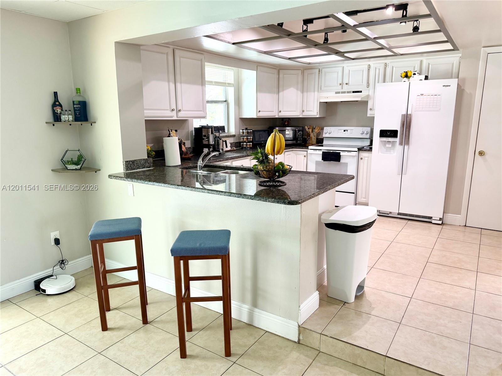 143 Valley Circle Brandon, FL 33510 - Photo 17 of 21 a kitchen with stainless steel appliances granite countertop a sink and a refrigerator