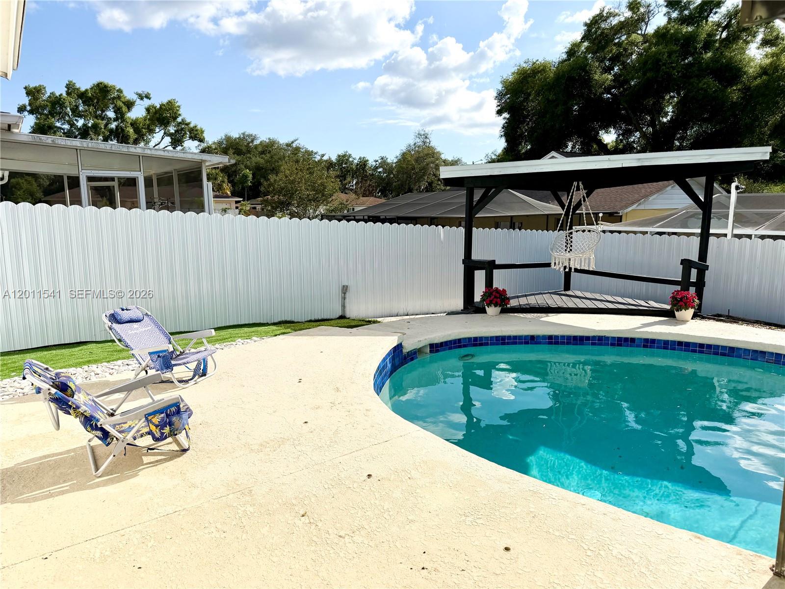 143 Valley Circle Brandon, FL 33510 - Photo 3 of 21 a view of a swimming pool with a lounge chairs