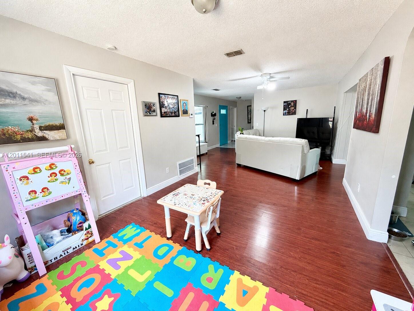 143 Valley Circle Brandon, FL 33510 - Photo 6 of 21 a living room with furniture and a wooden floor