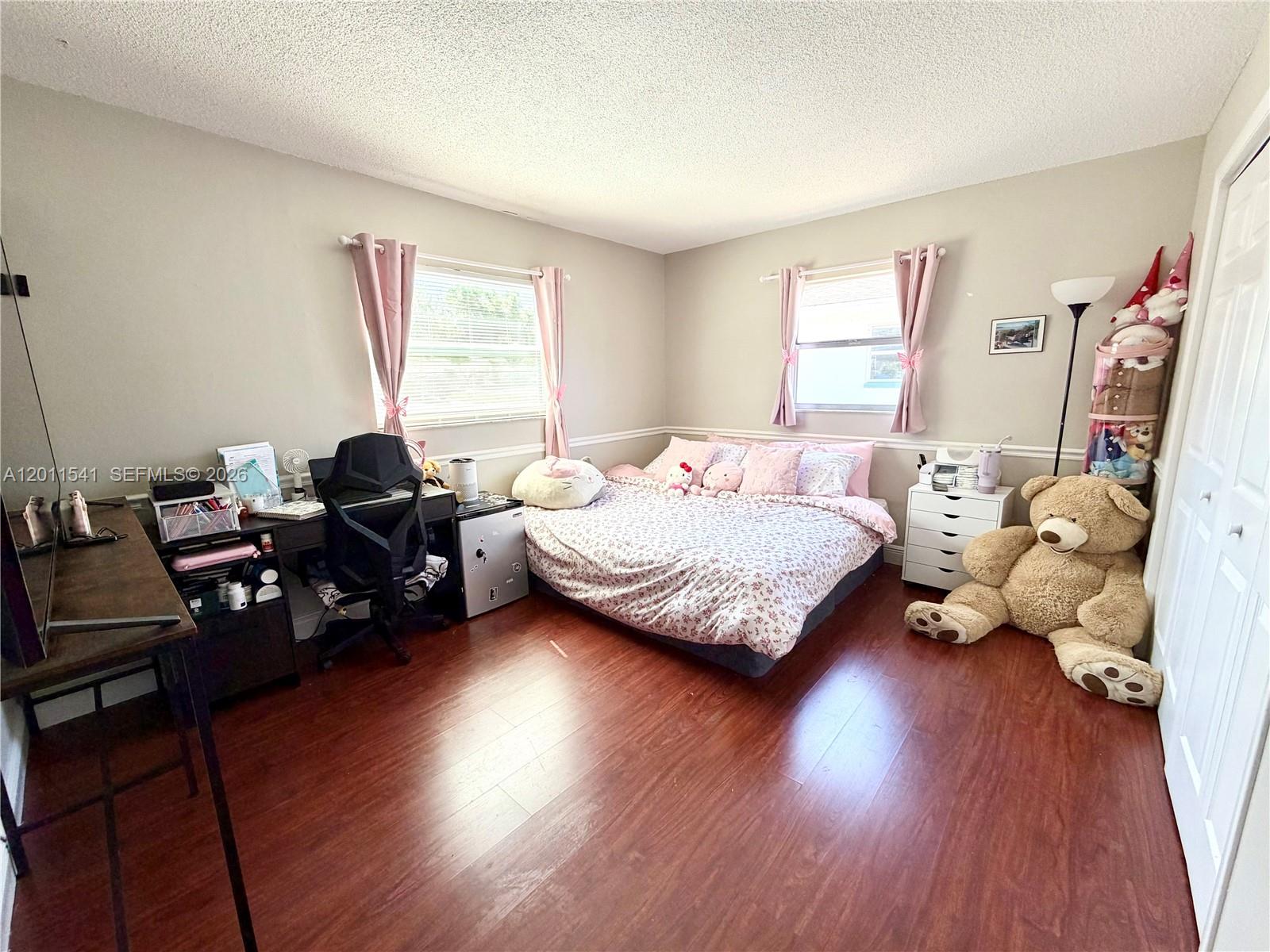 143 Valley Circle Brandon, FL 33510 - Photo 7 of 21 a bedroom with bed couch and window