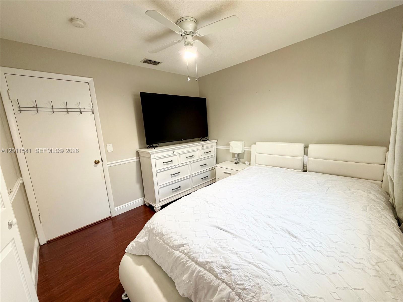 143 Valley Circle Brandon, FL 33510 - Photo 10 of 21 a bedroom with a bed and a flat screen tv