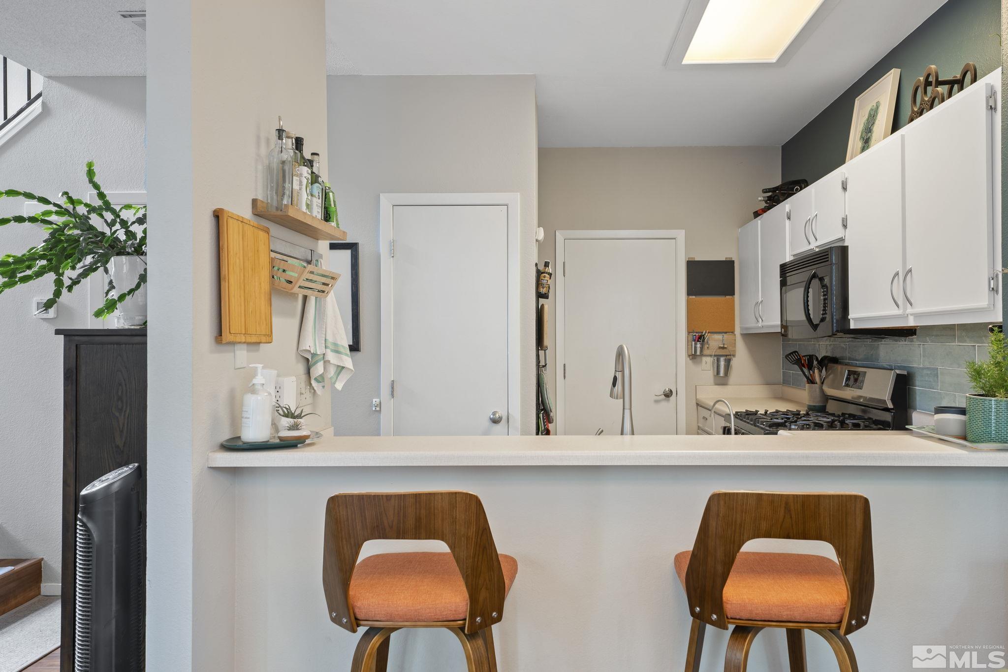 4391 Loreto Lane Reno, NV 89502 - Photo 14 of 39 a kitchen with stainless steel appliances granite countertop a sink and cabinets