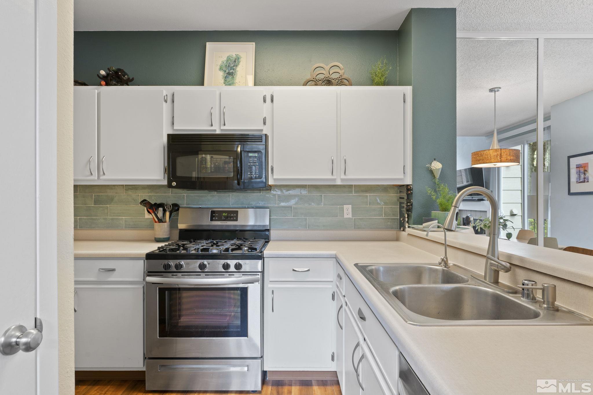 4391 Loreto Lane Reno, NV 89502 - Photo 15 of 39 a kitchen with granite countertop a sink and a stove top oven