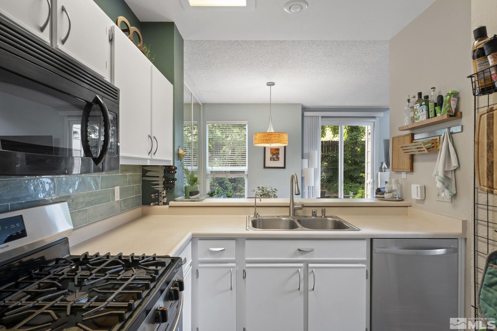 4391 Loreto Lane Reno, NV 89502 - Photo 16 of 39 a kitchen with a sink stove and cabinets