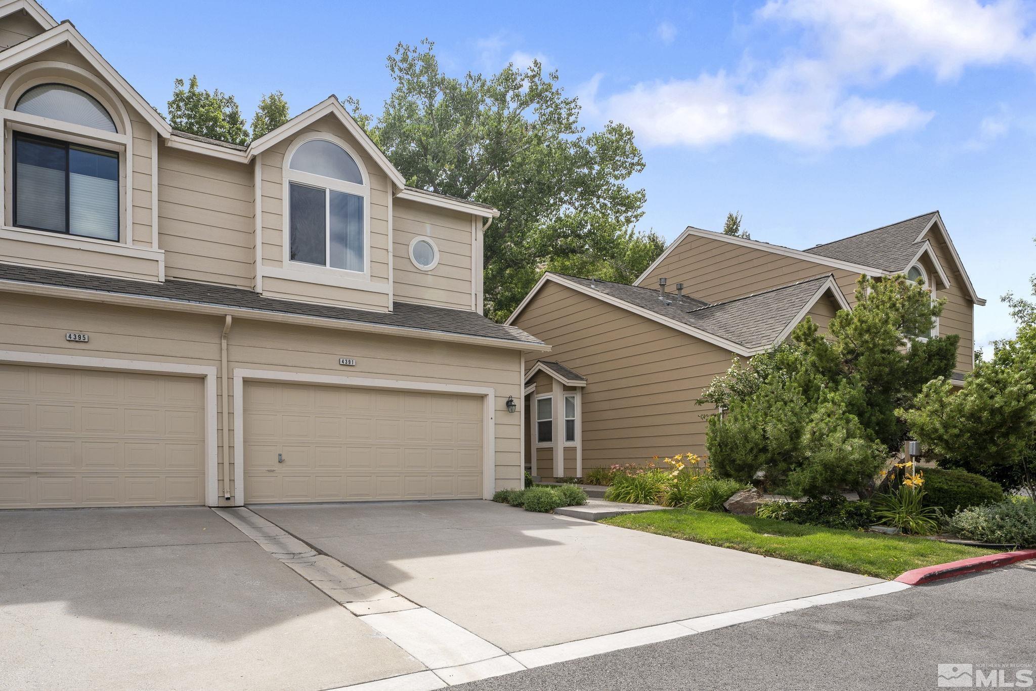 4391 Loreto Lane Reno, NV 89502 - Photo 2 of 39 a front view of a house with a yard and garage