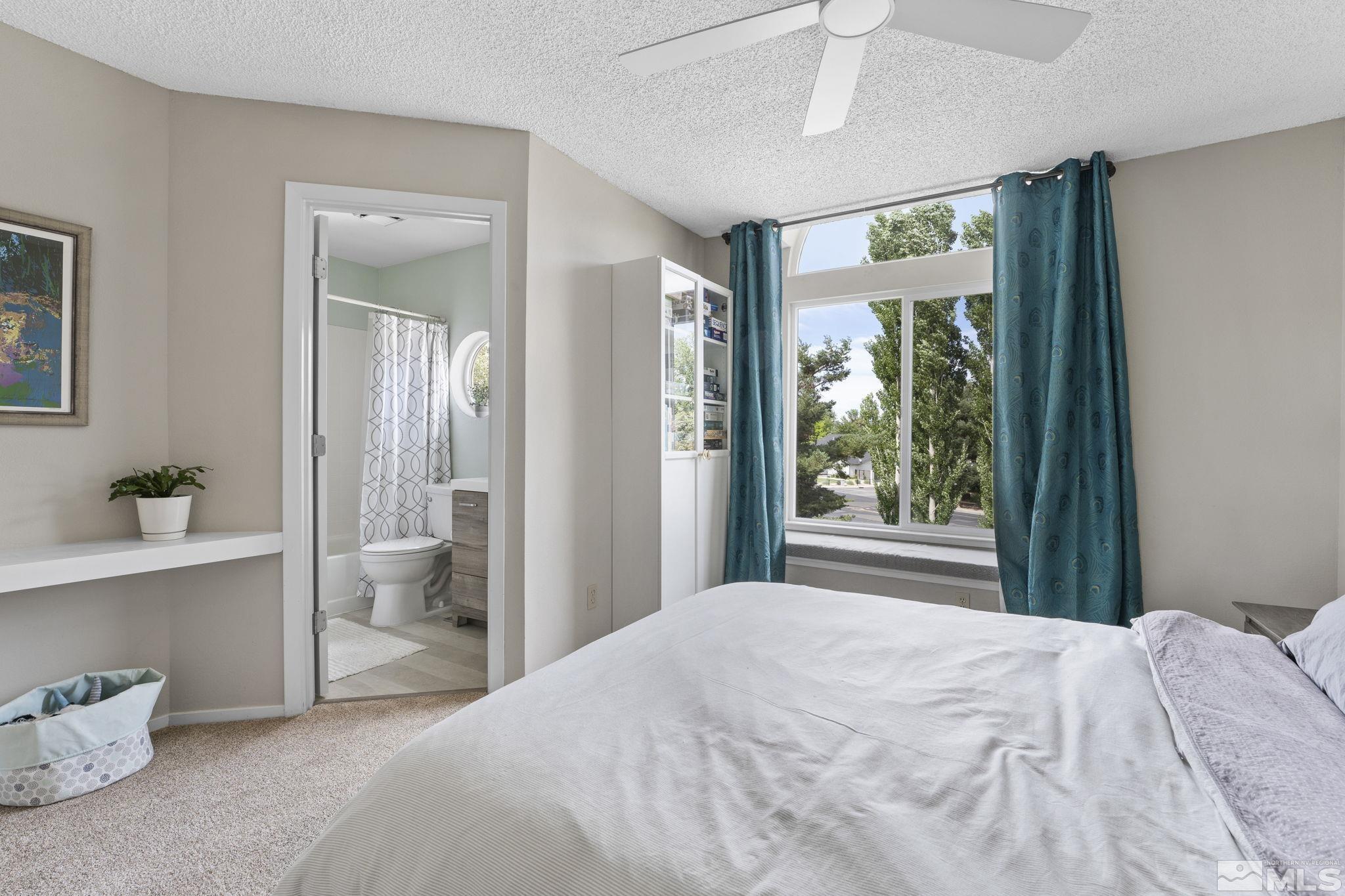 4391 Loreto Lane Reno, NV 89502 - Photo 25 of 39 a bedroom with a bed and a large window