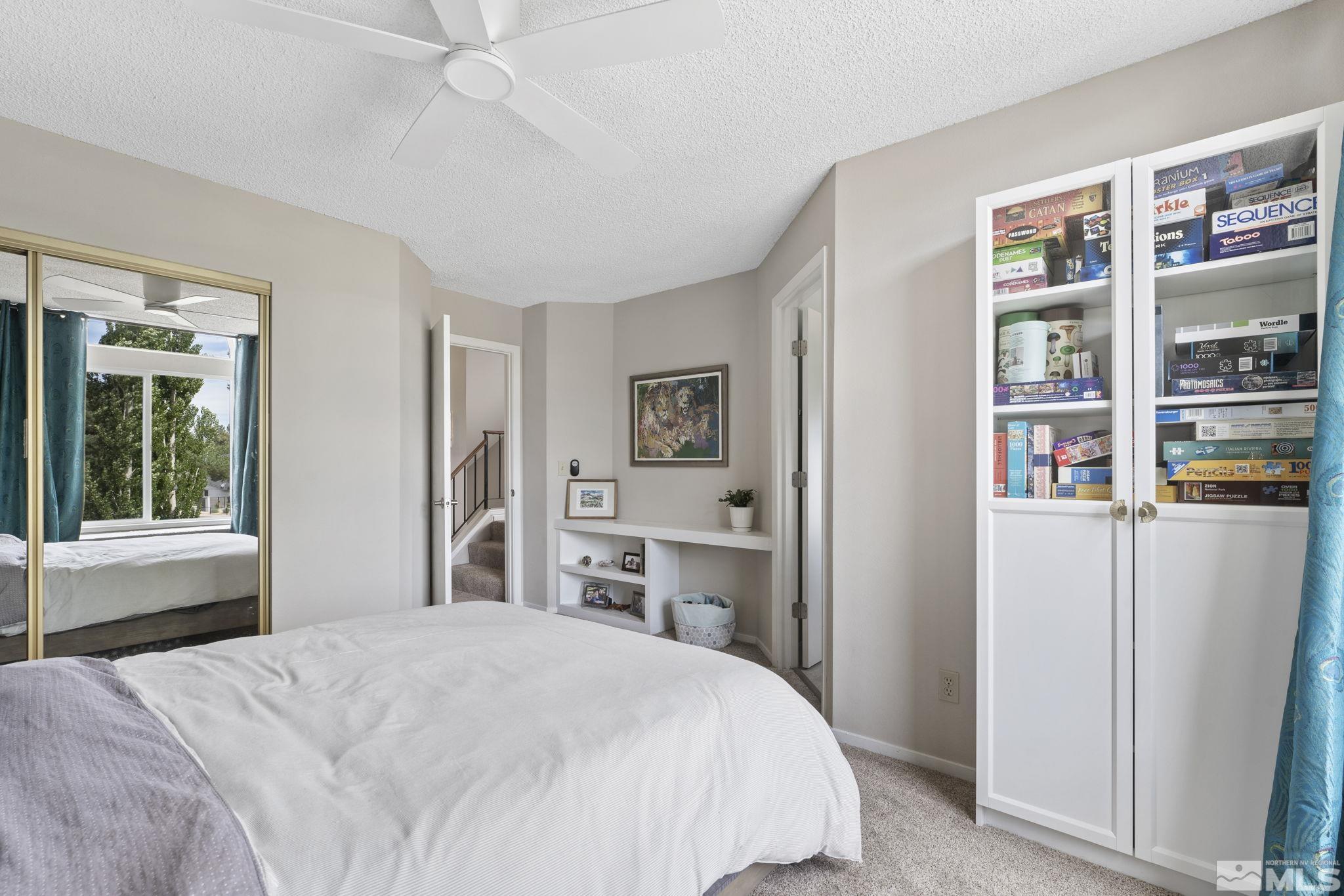 4391 Loreto Lane Reno, NV 89502 - Photo 26 of 39 a bedroom with a bed and a book shelf
