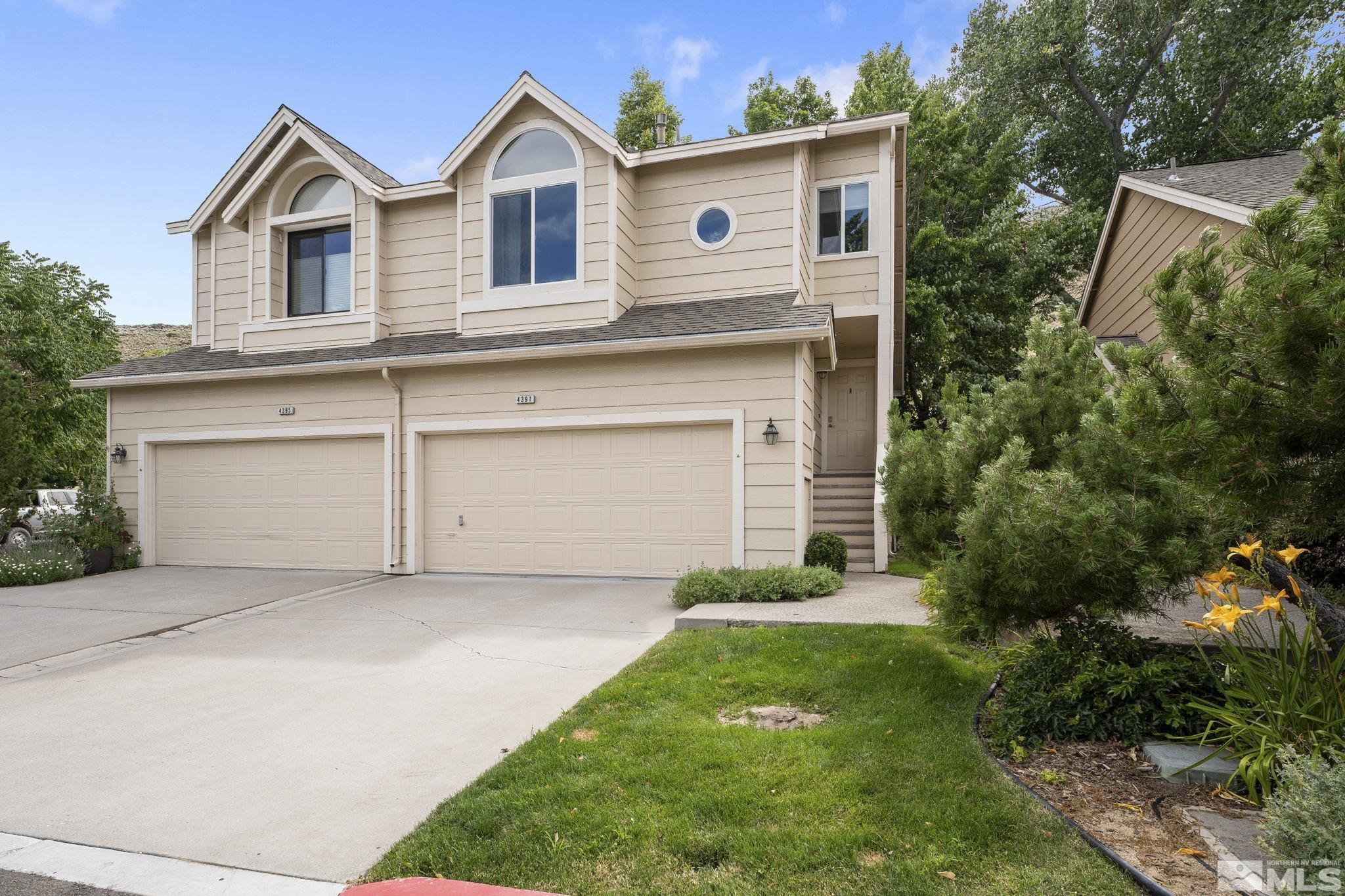 4391 Loreto Lane Reno, NV 89502 - Photo 3 of 39 a front view of a house with a yard and garage
