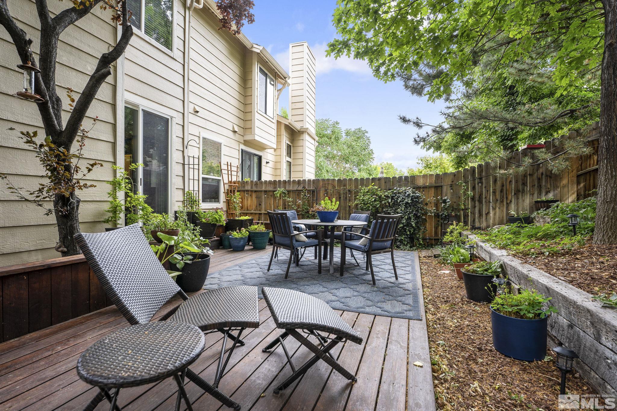 4391 Loreto Lane Reno, NV 89502 - Photo 37 of 39 a view of a patio with couches table and chairs and potted plants