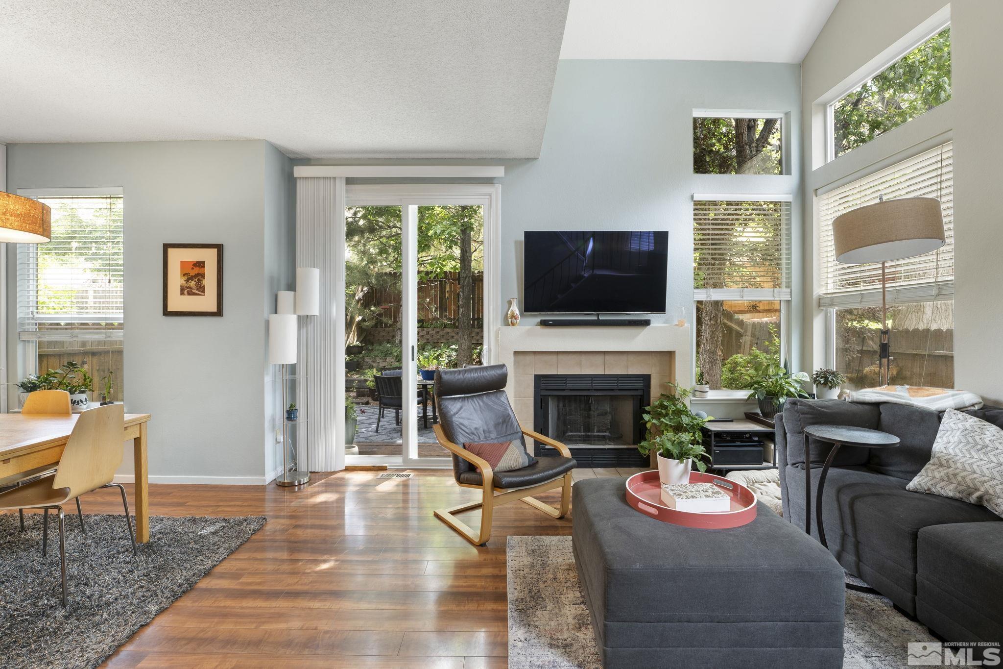 4391 Loreto Lane Reno, NV 89502 - Photo 6 of 39 a living room with furniture a fireplace and a flat screen tv