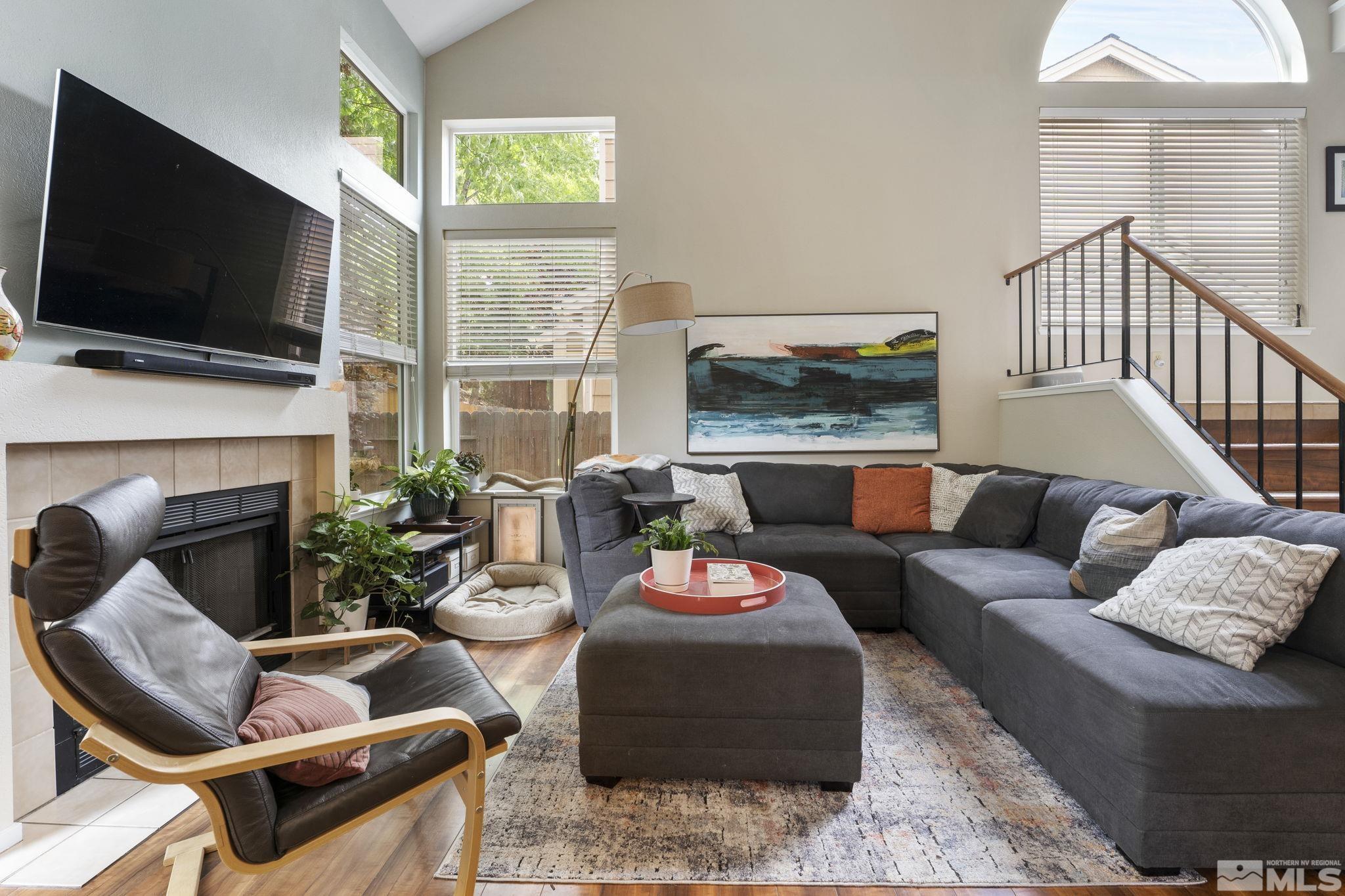 4391 Loreto Lane Reno, NV 89502 - Photo 7 of 39 a living room with furniture a flat screen tv and a fireplace