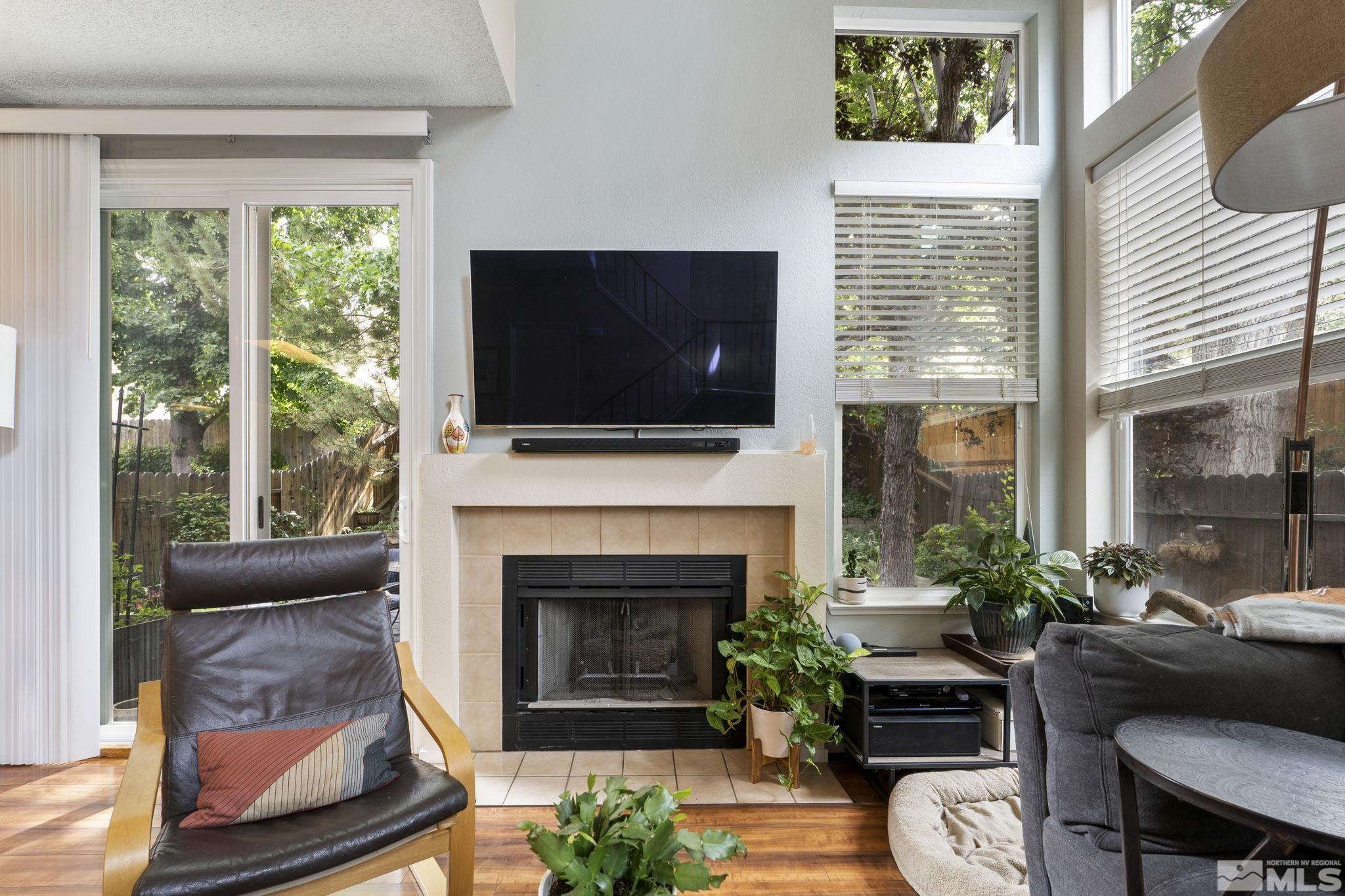 4391 Loreto Lane Reno, NV 89502 - Photo 9 of 39 a living room with furniture a flat screen tv and a fireplace