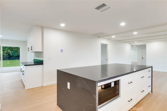 a view of microwave and cabinets