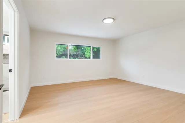 an empty room with windows and closet
