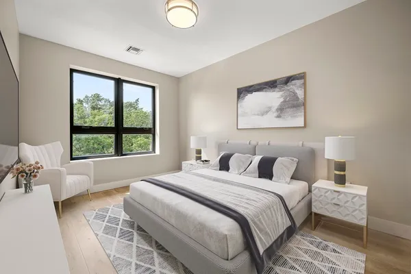 a bedroom with bed and a large window