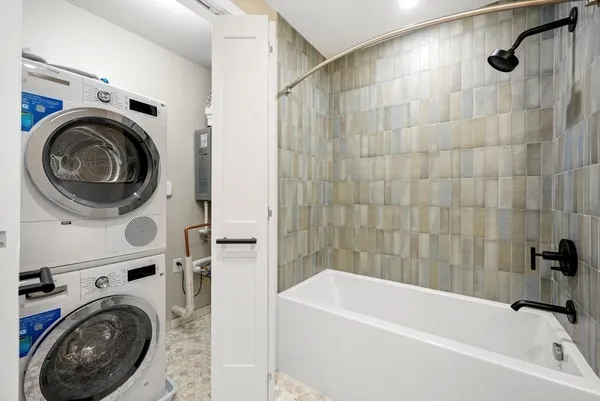 a bathroom with a sink a washer and dryer