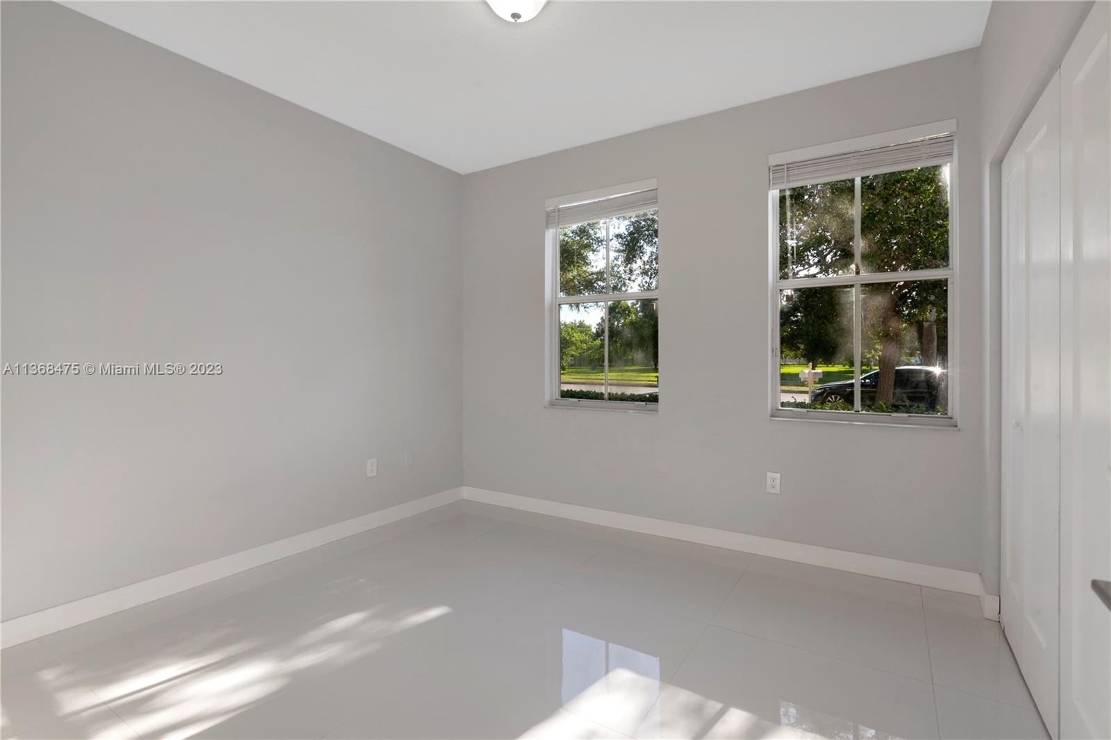 24547 Southwest 109th Avenue Homestead, FL 33032 - Photo 11 of 20 an empty room with windows