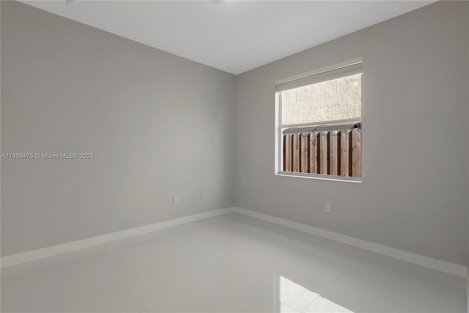 24547 Southwest 109th Avenue Homestead, FL 33032 - Photo 12 of 20 an empty room with windows