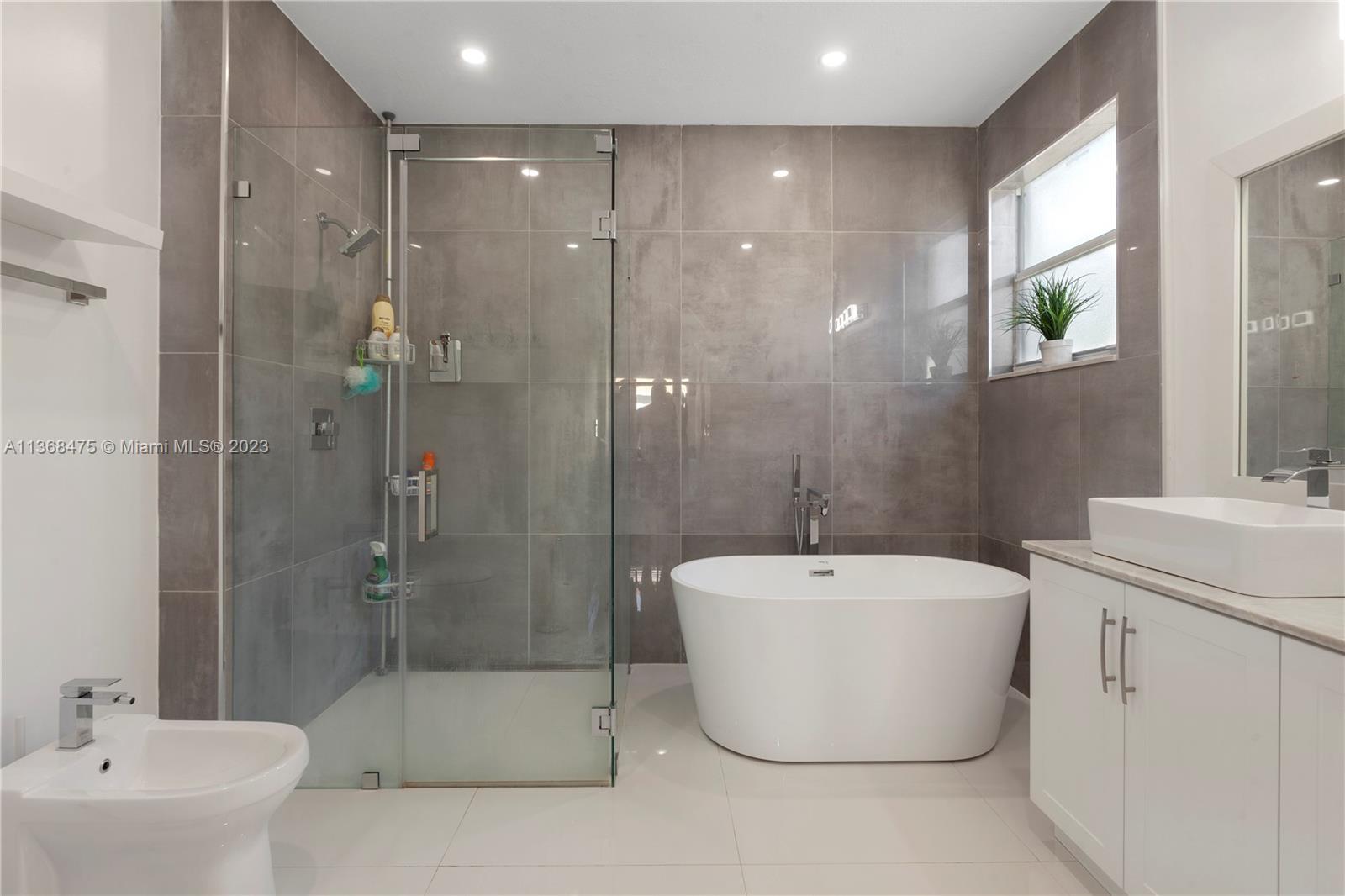 24547 Southwest 109th Avenue Homestead, FL 33032 - Photo 17 of 20 a white bath tub sitting next to a white sink