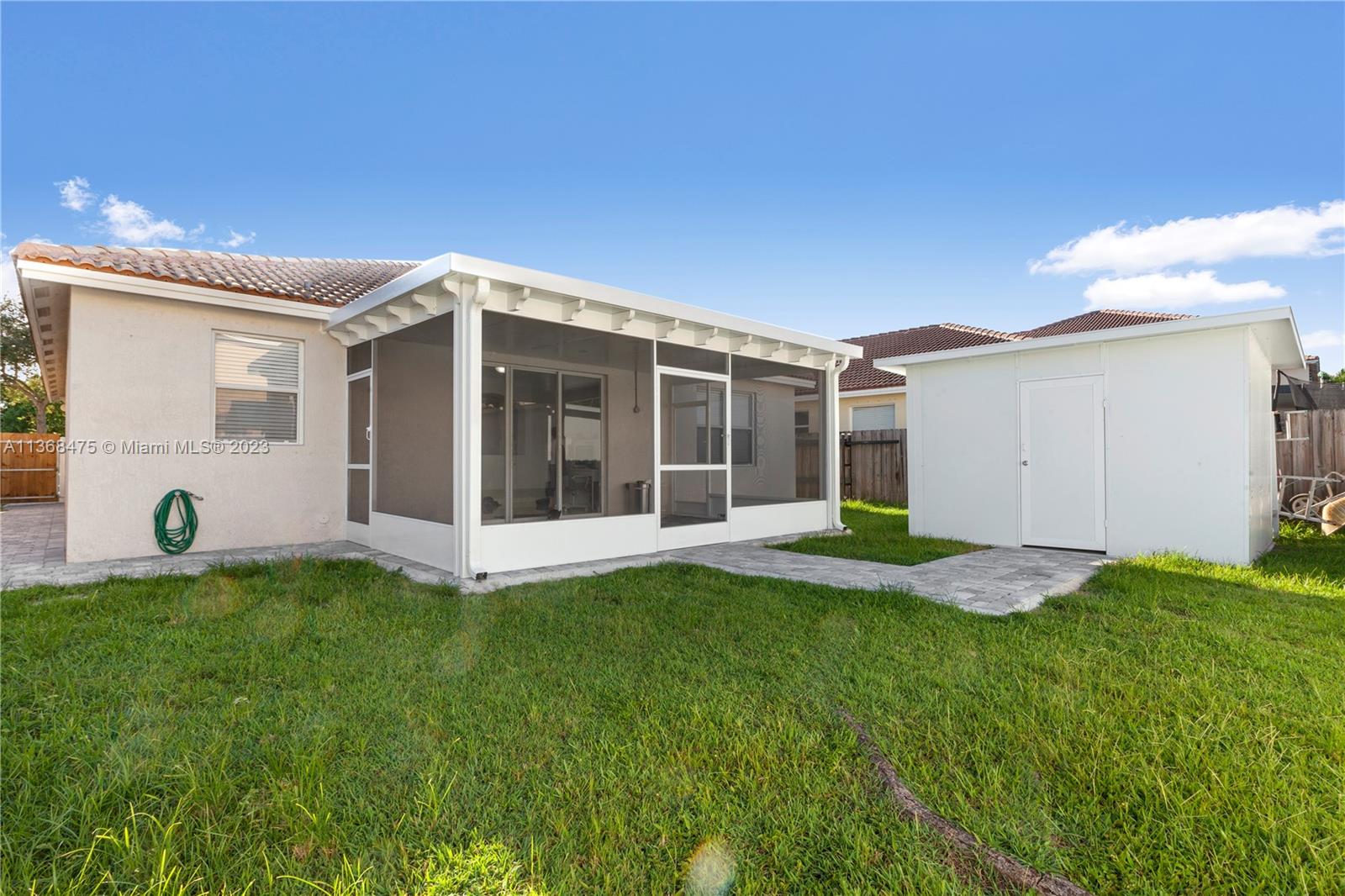 24547 Southwest 109th Avenue Homestead, FL 33032 - Photo 20 of 20 a view of a house with a yard and a porch