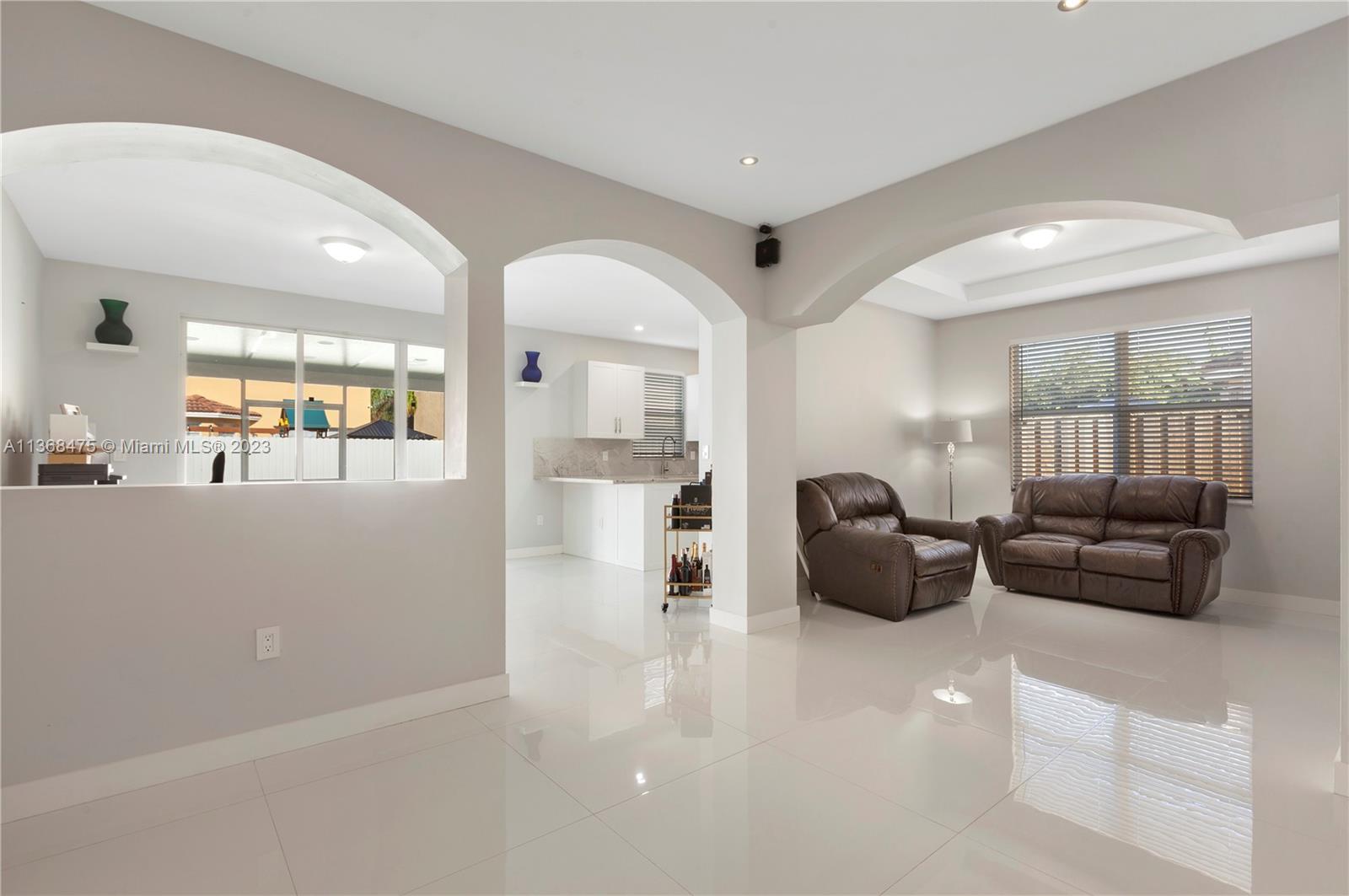 24547 Southwest 109th Avenue Homestead, FL 33032 - Photo 2 of 20 a living room with furniture and a large window