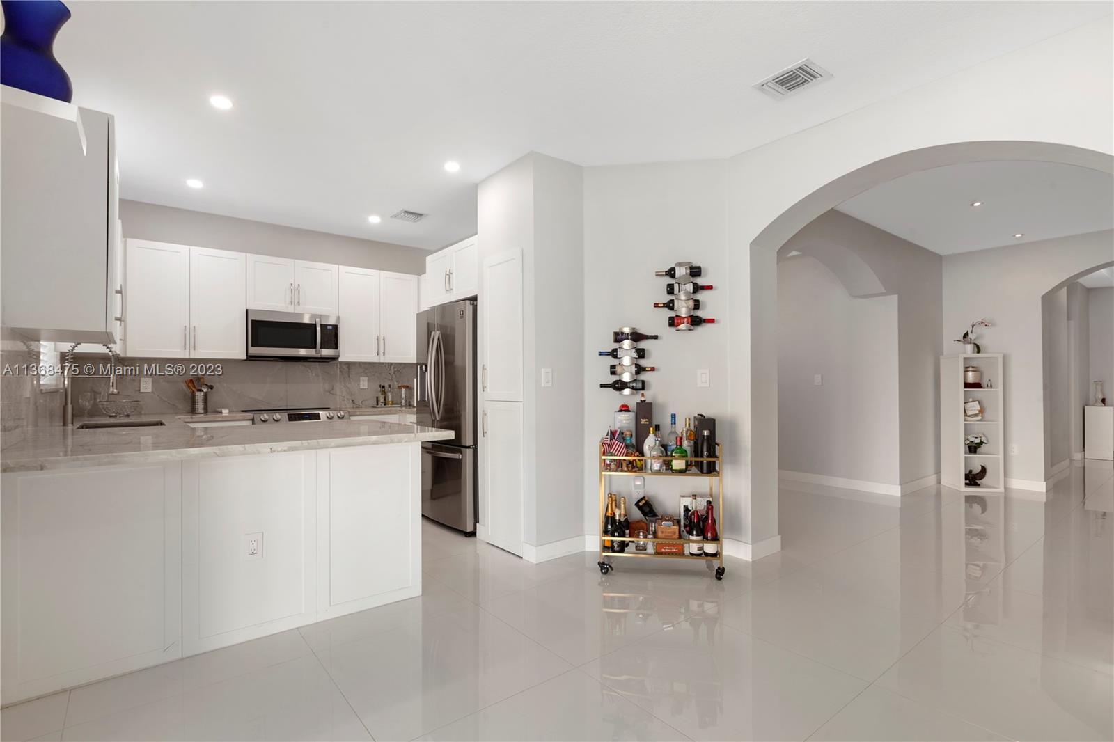 24547 Southwest 109th Avenue Homestead, FL 33032 - Photo 8 of 20 a view of a kitchen with refrigerator and microwave