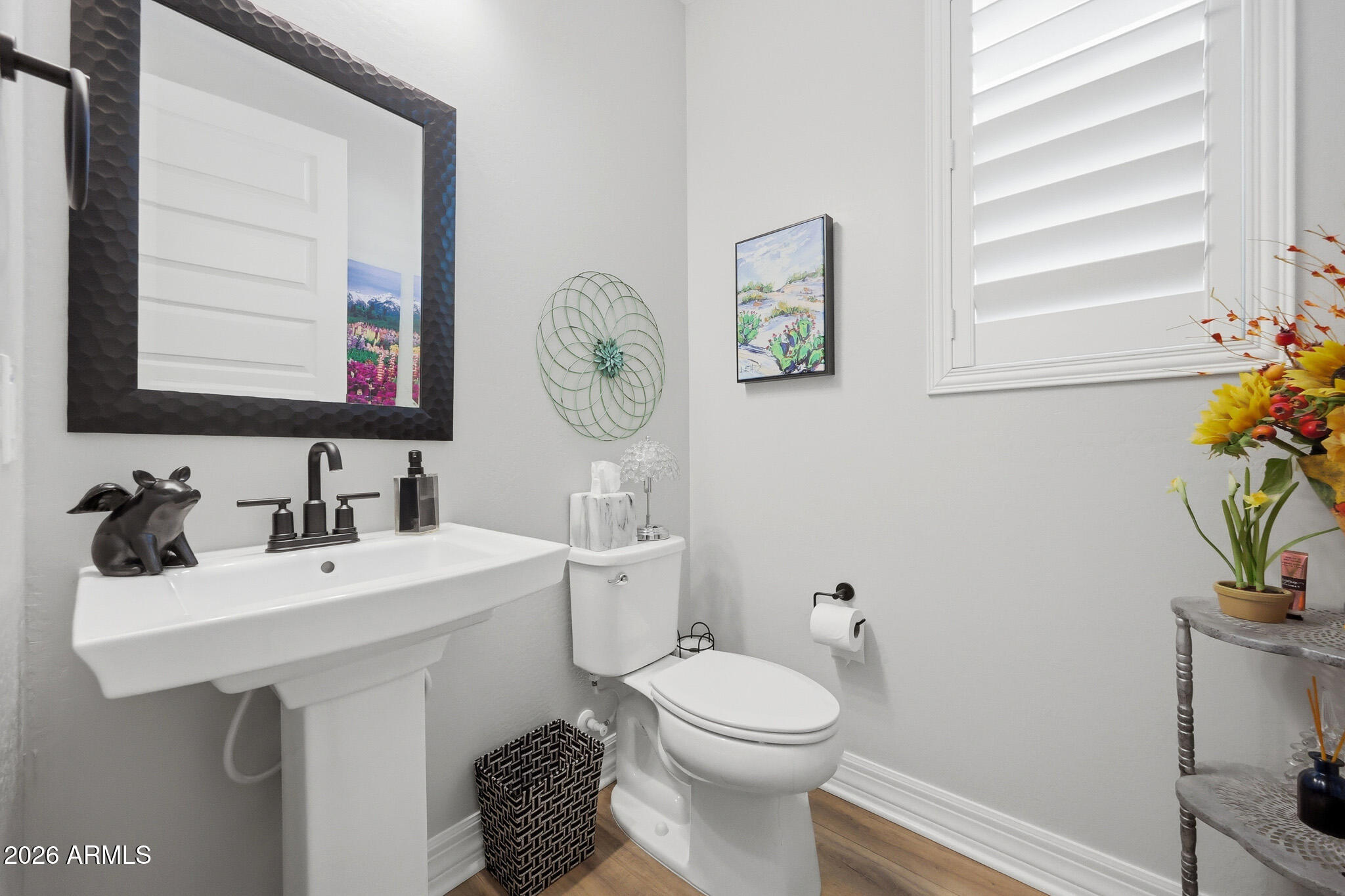 20636 West Luke Avenue Buckeye, AZ 85396 - Photo 19 of 42 a bathroom with a toilet sink and mirror