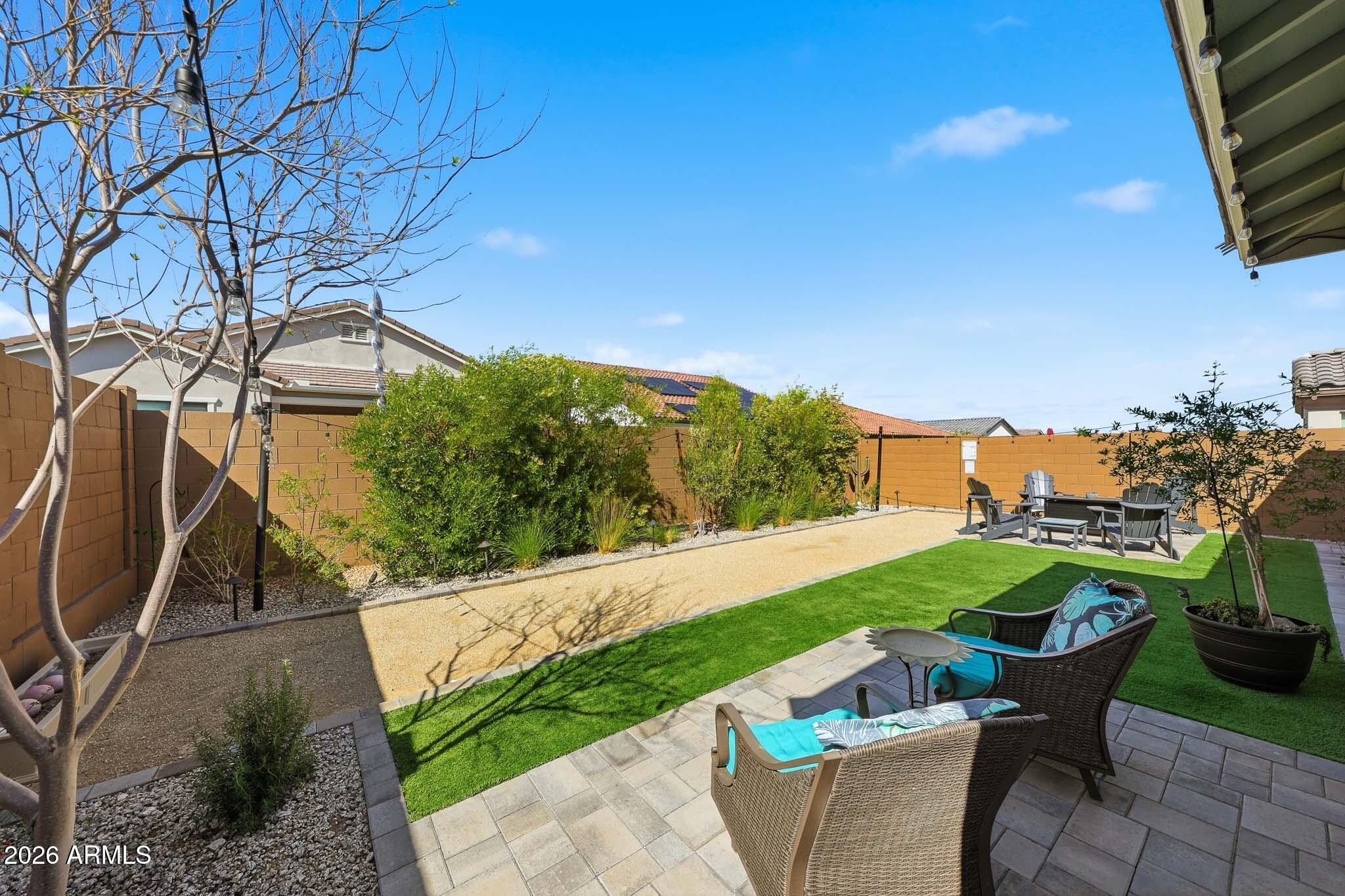 20636 West Luke Avenue Buckeye, AZ 85396 - Photo 25 of 42 a patio with table and chairs and potted plants