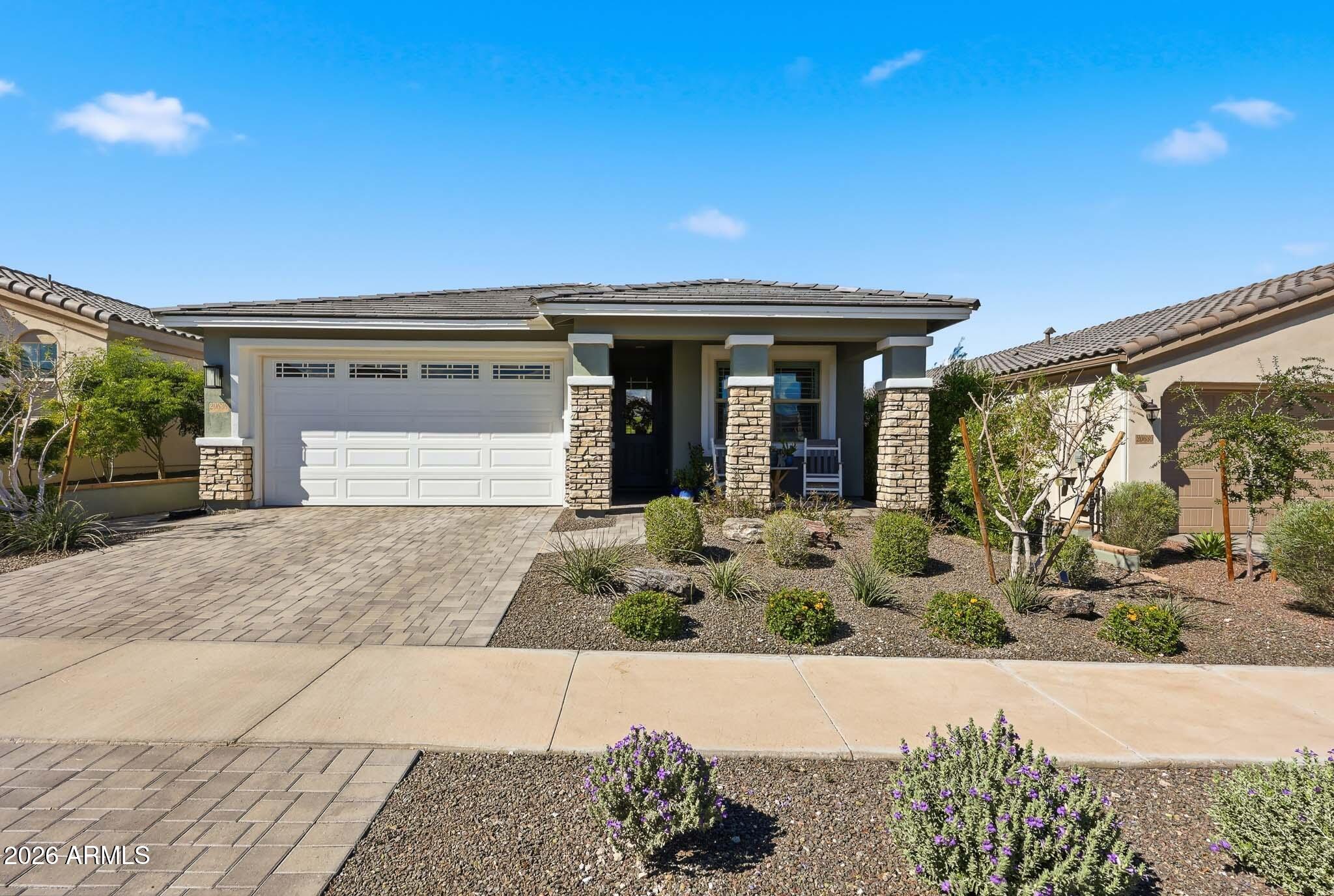 20636 West Luke Avenue Buckeye, AZ 85396 - Photo 27 of 42 a view of a house with potted plants