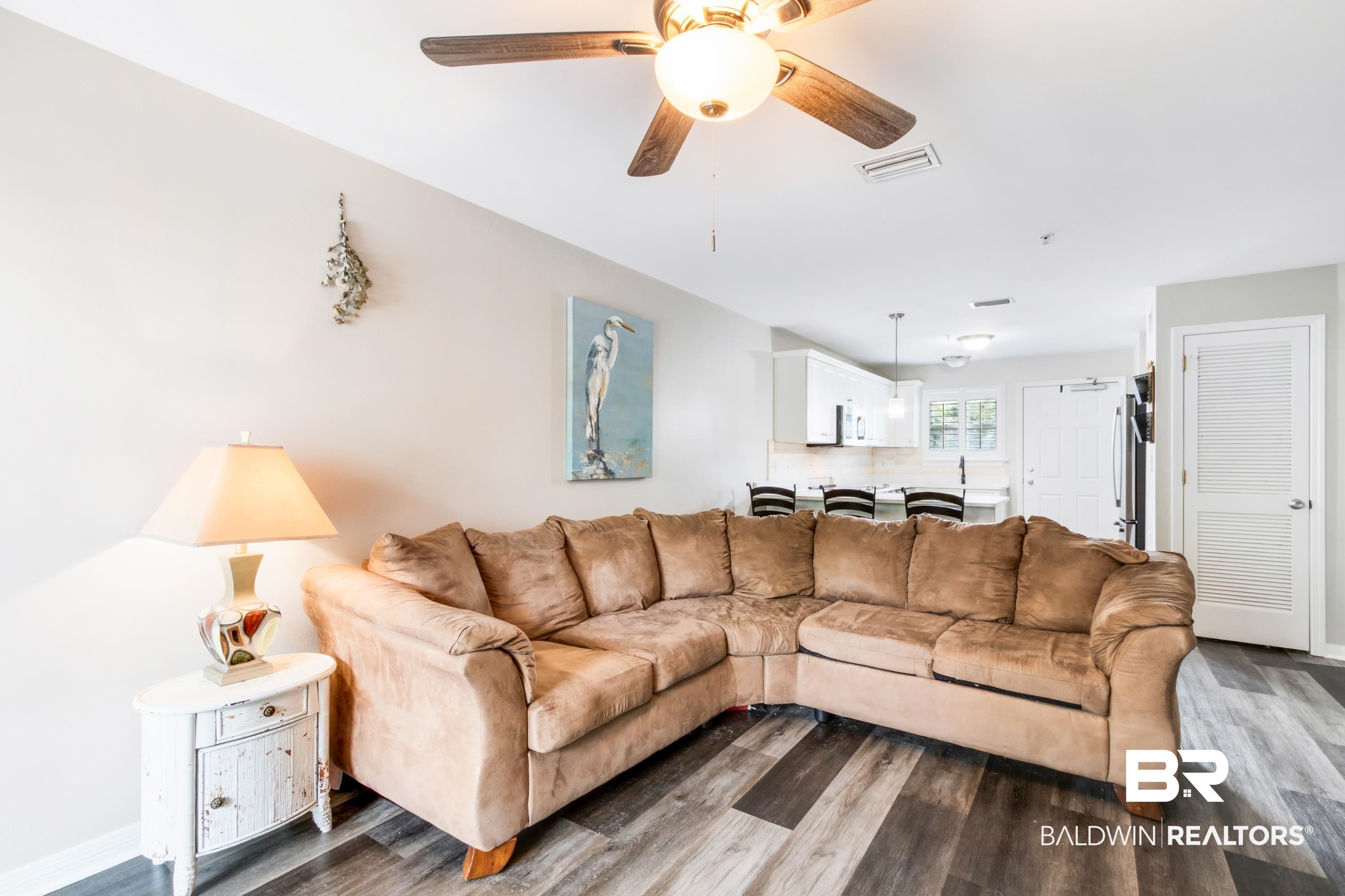25957 Canal Road, Unit 208 Orange Beach, AL 36561 - Photo 2 of 28 Open-concept living space featuring wood-finish flooring, a ceiling fan, and light wall tones