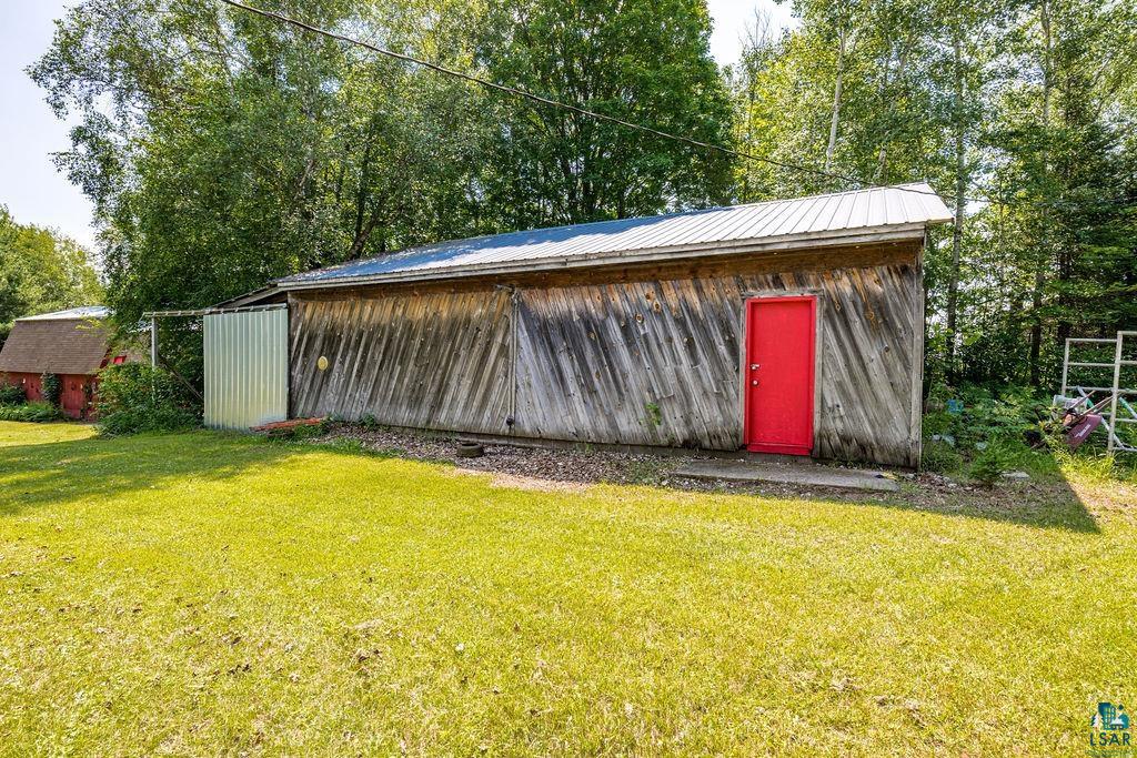 2592 Strandberg Road Barnum, MN 55707 - Photo 14 of 44 Outbuilding featuring wood siding, a red door, and a metal roof