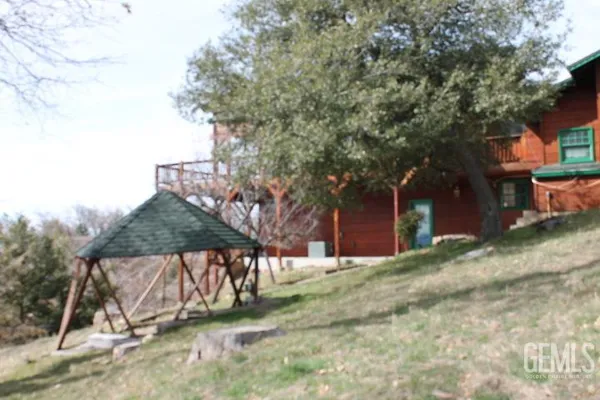 a bedroom with a large bed and wooden floor