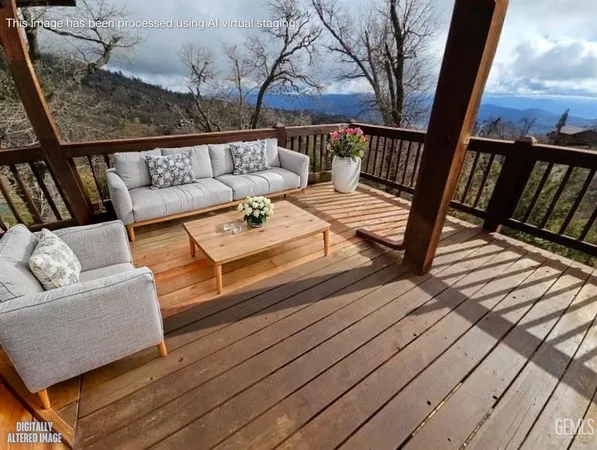 a view of a balcony with furniture and a flat screen tv