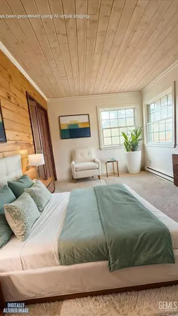 a view of a hallway with wooden floor and furniture