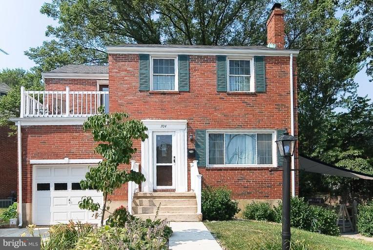 704 Charing Cross Road Baltimore, MD 21229 - Photo 1 of 20 a front view of a house with garden