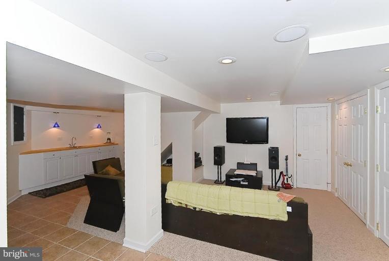 704 Charing Cross Road Baltimore, MD 21229 - Photo 3 of 20 a room with furniture and a flat screen tv