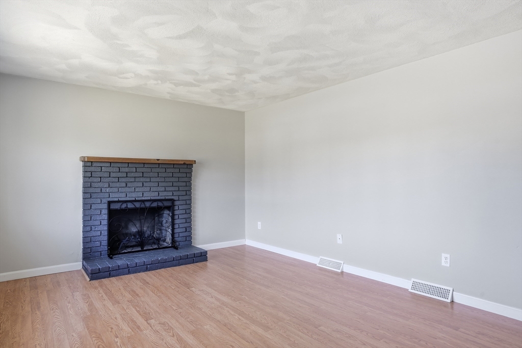 160 Navillus Road Tewksbury, MA 01876 - Photo 4 of 40 a room with a fireplace