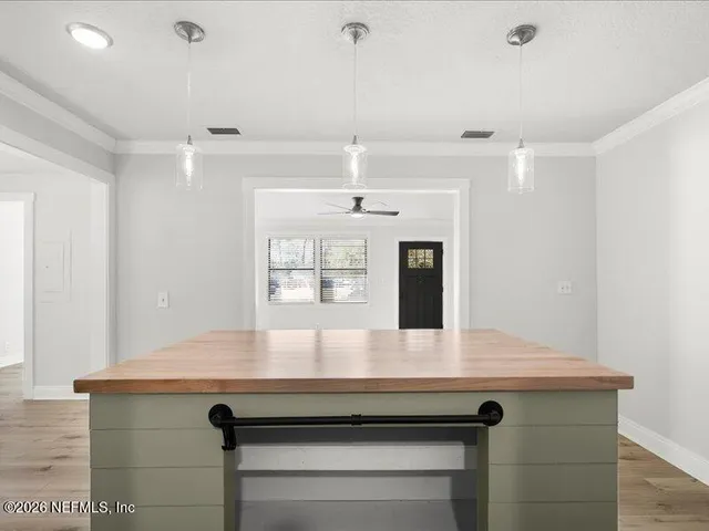 a view of kitchen with sink microwave and refrigerator