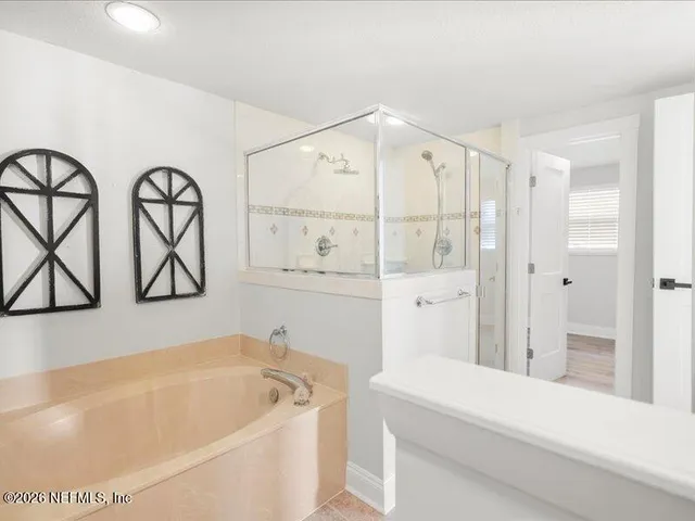 a bathroom with a bathtub and a shower